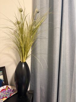 Black vase with artificial plant