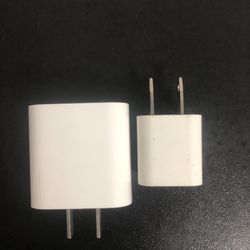 Two charger heads (without cables), one large and one small, white