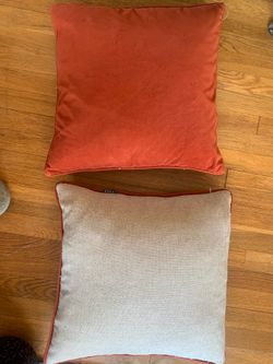 two orange and white throw pillows