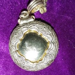 Ornate Silver Pendant. Floral Decorations Encircling.