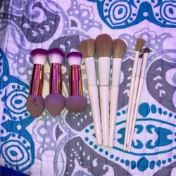 Makeup Brushes And Three Makeup Brushes With Sponges At The End.