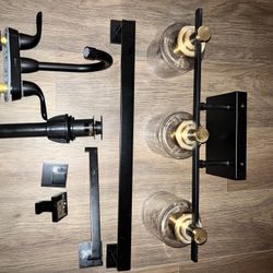 Bathroom remodel black matte with Gold Accents triple Glass Scone light fixture, 2 Black towel rods, 2 Black hooks and 1 Toilet Paper Holder