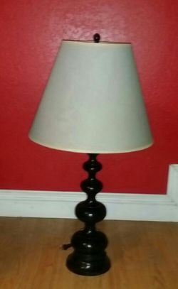 Black tall table lamp made out of wood...outs over 2ft tall..great condition!