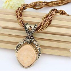 Beautiful beige and brown rope necklace with beige pendant new
