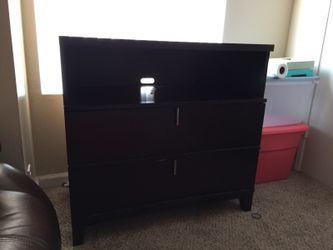 Brown wooden entertainment stand with 2 large draws on the bottom