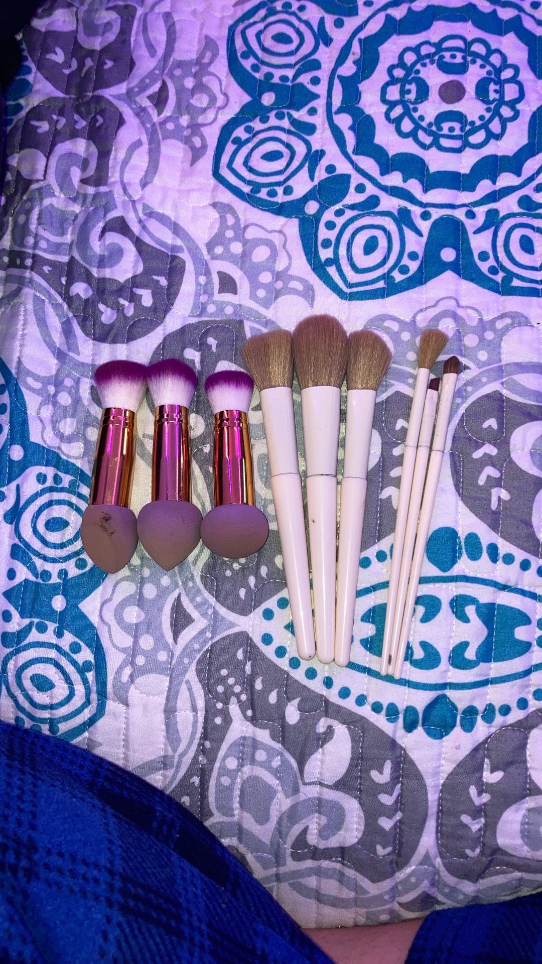 Makeup Brushes And Three Makeup Brushes With Sponges At The End.