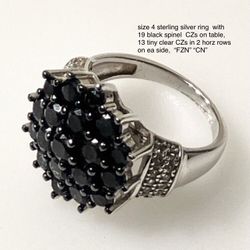 Size 4 sterling silver ring , with 19 black spinel  CZs, 13 clear CZs in 2 horz rows on sides