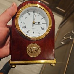 A polished wooden commemorative clock with a brass plaque commemorating NECA's 100th anniversary (1(contact info removed)).