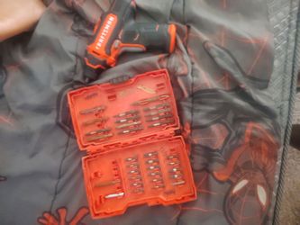 Drill wit drill bits and a box of drill bits