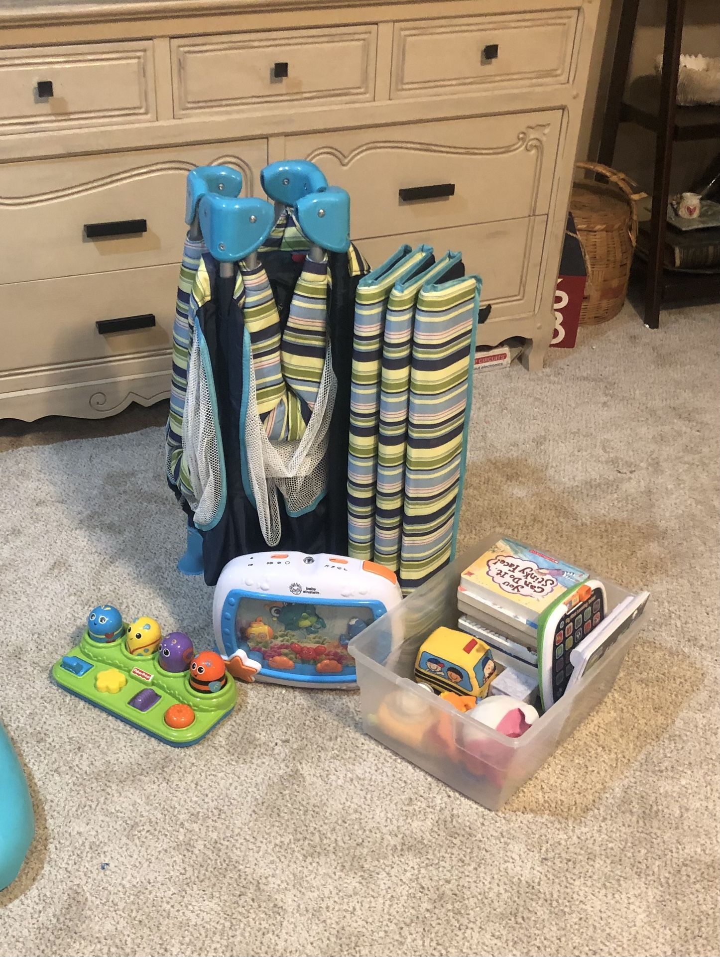 Pack and play nighttime sleeping kids, toys books all together