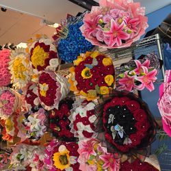 Vibrant artificial flower bouquets. Many different styles and colors available. Red, yellow, pink, white, black, blue, purple roses. Some bouquets hav