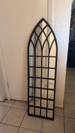 Black arched metal mirror