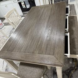 Kitchen/dining room table with four chairs in a bench