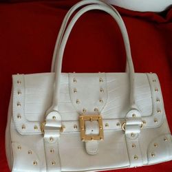 Michael Michael Kors  Rare! Purchased Saks Fifth Avenue.  Features gold toned studs and faux buckle on  Four interior slip pockets and two zippered po