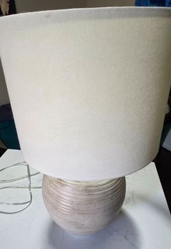 Hampton Bay Finch 22 in. Distressed White Ribbed Table Lamp featuring a round, ribbed, distressed white base