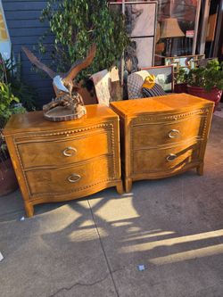 Pair of wooden nightstands with curved fronts and a black pull-out tray.