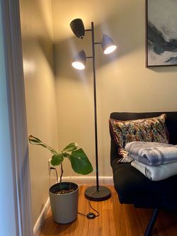 Modern black floor lamp with adjustable lights.
