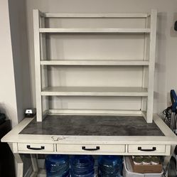 Solid Ashley Furniture desk and matching cream-colored bookshelf with built-in drawers for storage.