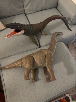 Two colossal Jurassic world/park dinosaurs brachiosaurus and mosasaurus