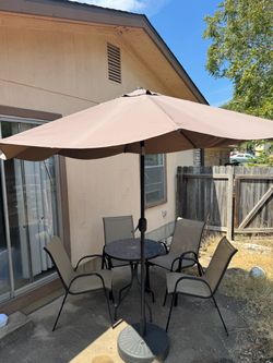 Patio table, chairs and umbrella.