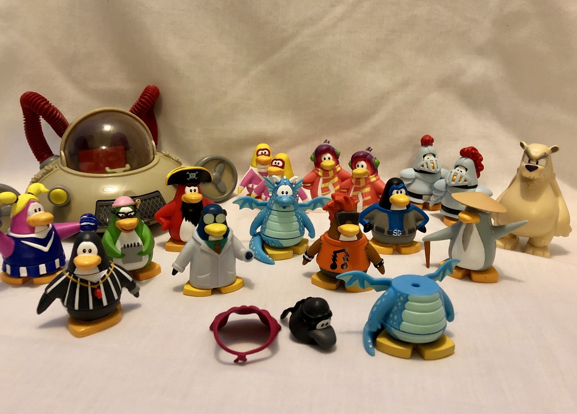Club Penguin figures and vehicle.