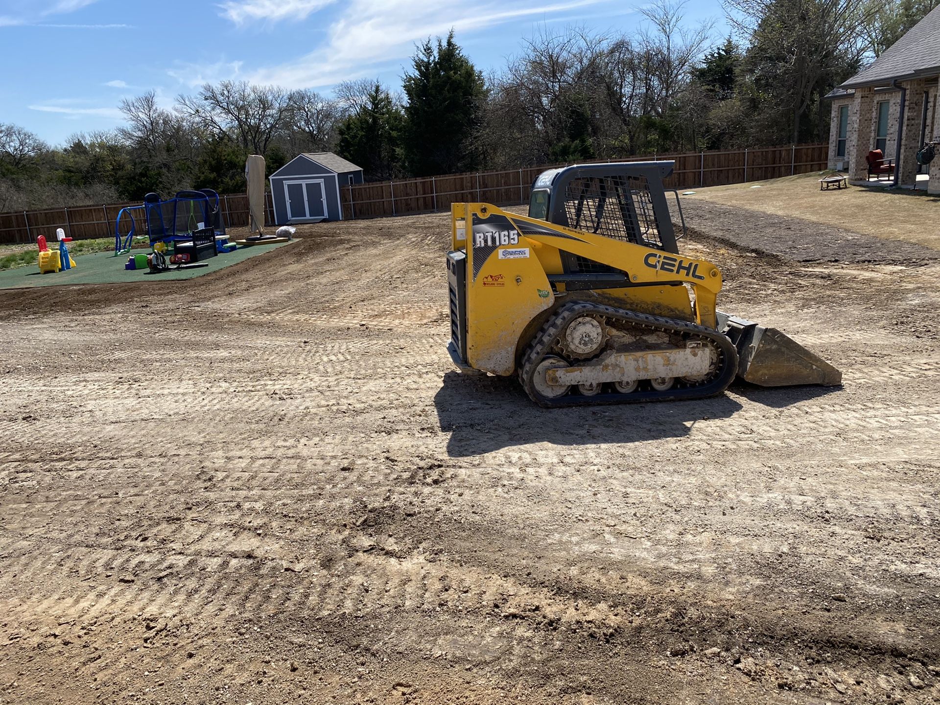 Bobcat skid steer work grading leveling. Sod installation