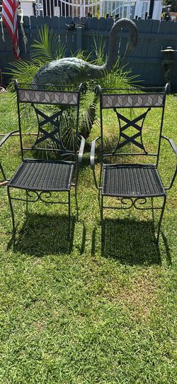 Chairs Durable outdoor chairs  Set of 2 chairs with black  wrought iron frames and woven wicker seats. Each chair has a decorative mosaic tile inlay a
