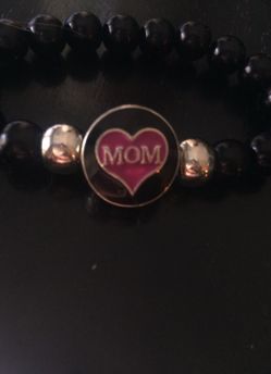 Black glass beaded bracelet with two charms