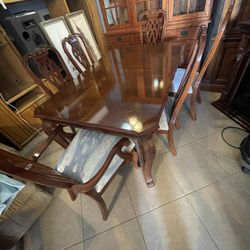 Wooden dining room, table, and chairs