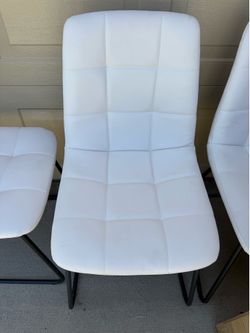 White leather chairs with small table
