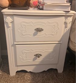 Queen bed and white night stand and desk