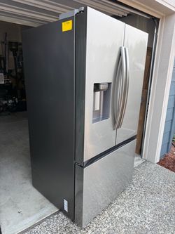 Samsung French door refrigerator (never used).  30.5 Cu.Ft capacity.