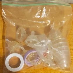 Bag Of extra bottles nipples and bottles caps
