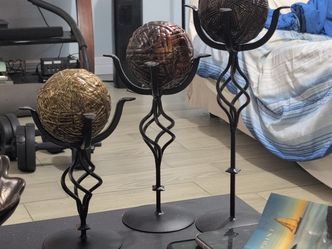 decorative iron candle holders with sphere accents.