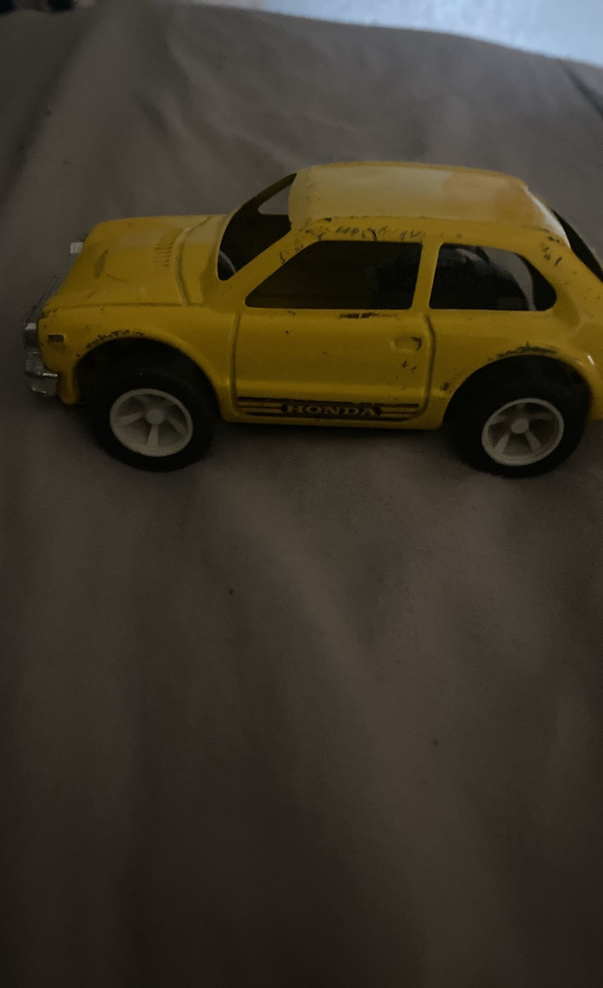 old vintage toy Honda Tonkawa toy car yellow
