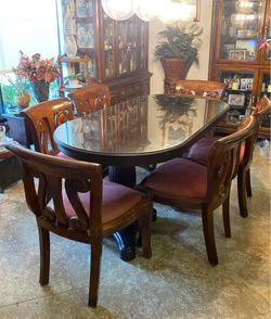 Oval glass top mahogany dining room table with 6 chairs w padded seats