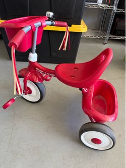 Blue ride on and radio flyer tricycle