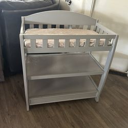 Baby changing table with pad and sheet