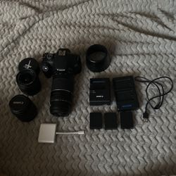canon rebel t7 with 3 lenses 18-55, 35-80 and 75-300 3 batteries, fish eye lens and a small carry case