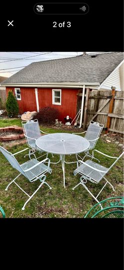 Wought iron patio set, table with 4 bouncy chairs