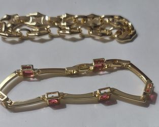 Gold tone bracelet featuring pink crystals & link bracelet