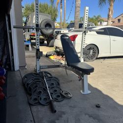 Bench press/squat rack with 7ft 45lbs bar plus 250lbs of Olympic weights and curl bar