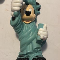 This is a Disney Minnie Mouse Statue of Liberty coin bank or figurine