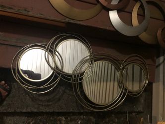 Four metal circles with round mirrors