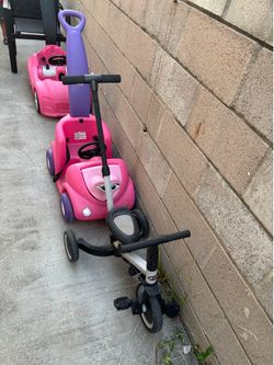 2 pink girls push car and 1 training bike