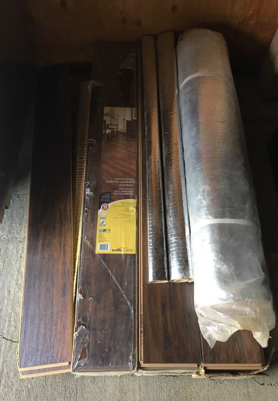 6 boxes of TrafficMaster “Farmstead Hickory” glueless laminate flooring with underlayment.