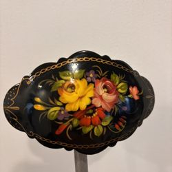 Russian hand-painted lacquer brooch featuring a floral design