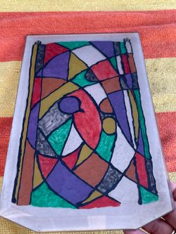 decorative glass panel featuring a vibrant, abstract mosaic design reminiscent of stained glass