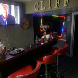 Pool Table And Bar With Bar Tables And Stools