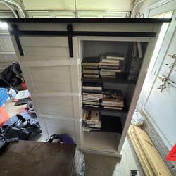 White book shelf with barn sliding door.